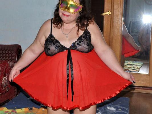 My bbw wife is in a red dress and mask.