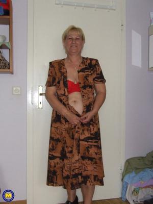 Granny removes red lingerie and poses nude in bedroom