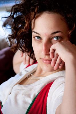 Girl in blue panties lounges on a futon