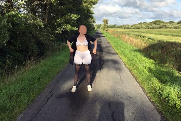 yo- posing on a street showing white lingerie